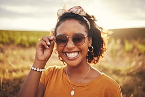 Pretty African Lady wearing sunglasses and smiling